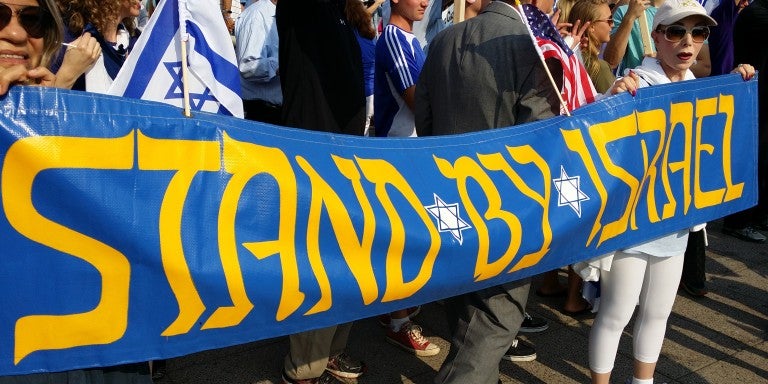 Photo of a parade banner displaying Stand by Israel