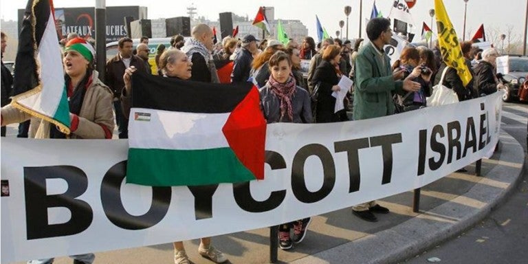 Photo of a BDS march with a large Boycott Israel banner