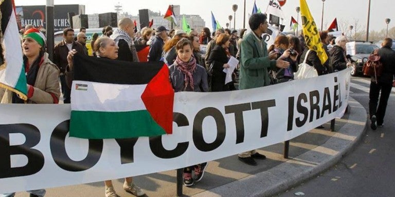 Photo of a BDS march with a large Boycott Israel banner