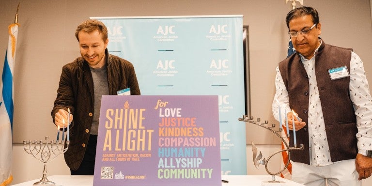 AJC Los Angeles 2022 Hanukkah - Melvoin and Chopra light candles