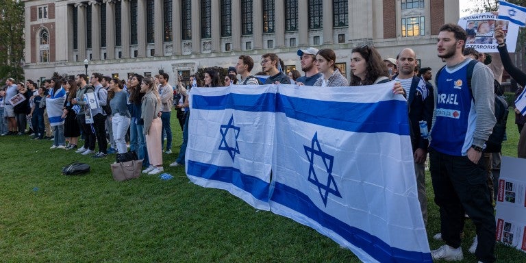 students on campus holding Israeli flags
