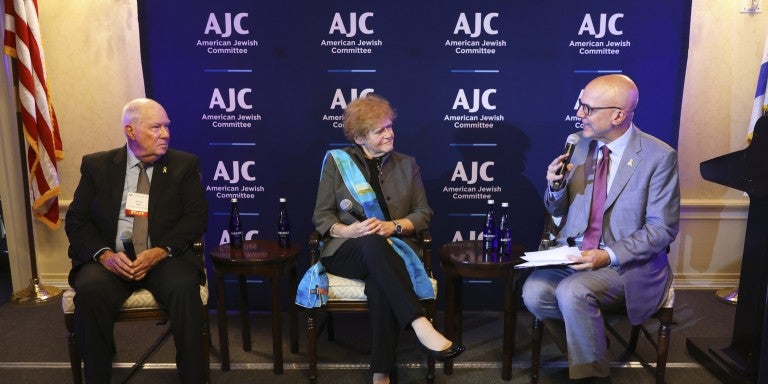 Photo of Amb. Lipstadt, AJC CEO Ted Deutch, and Rabbi Andy Baker speaking