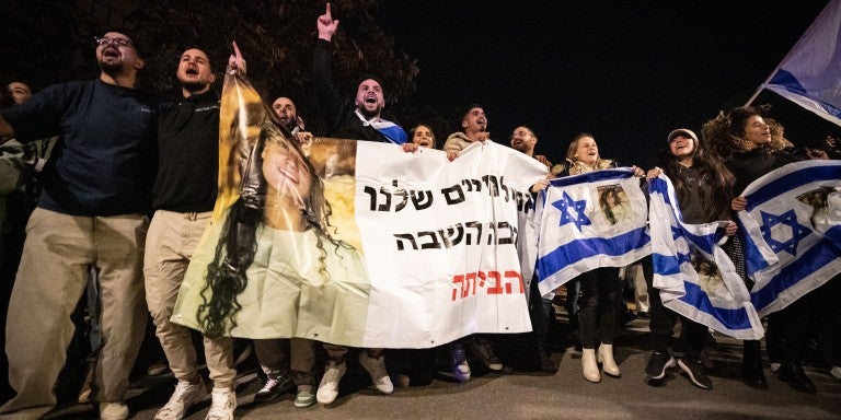 People celebrate the release of Isreali hostages from Hamas captivity at Sheba Medical Center in Ramat Gan, Israel, Jan. 19, 2025. Three Israeli women, released from Hamas captivity in Gaza, arrived in Israel on Sunday, the first day that a ceasefire agreement between Israel and Hamas took effect, according to Israeli officials. The three -- Emily Damari, 28, a British-Israeli; Doron Steinbrecher, 30, a veterinary nurse; and Romi Gonen, 23, abducted from the Nova music festival -- were finally released afte