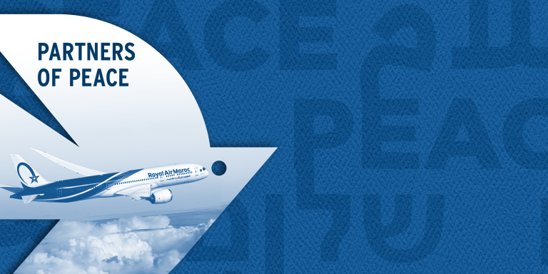 White dove over a dark blue background with peace written in three languages: Hebrew, Arabic, and English. Photo inside the dove reads "Partners of Peace" and shows an image of a Royal Air Maroc plane in flight, over clouds.