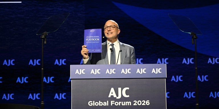  AJC CEO Ted Deutch at a podium Unveiling AJC’s New Combating Antisemitism Playbook at Global Forum 2026