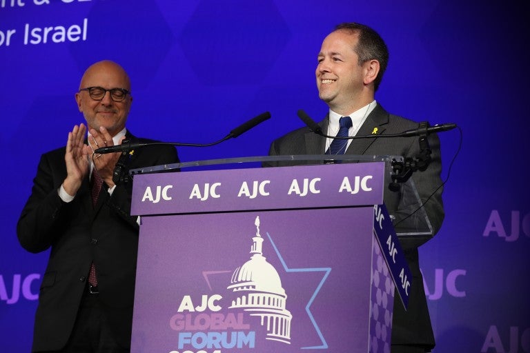 Image of AJC CEO Ted Deutch and Dan Elbaum at the podium of AJC's 2024 Global Forum
