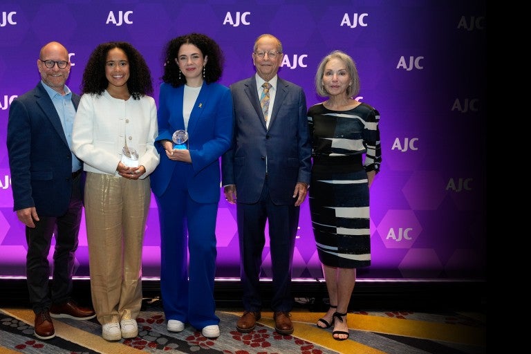 Image of Bill, Susan, and Josh Greene presenting the AJC Sharon Greene Award for Campus Advocacy to Hannah Veiler and Noa Fay at AJC's 2024 Global Forum
