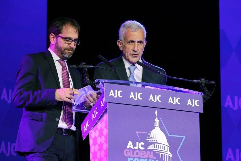 Image of Danny Pomerantz at the podium giving a speech on Remembering the AMIA Bombing