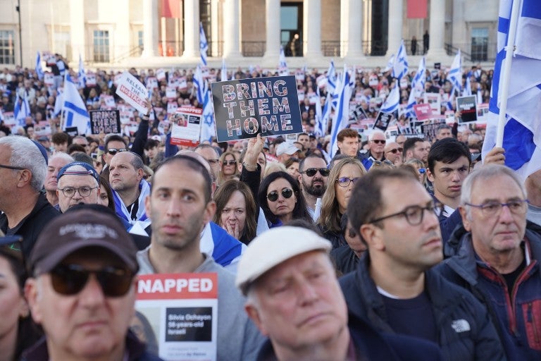 Crowd holding a Bring Them Home signs