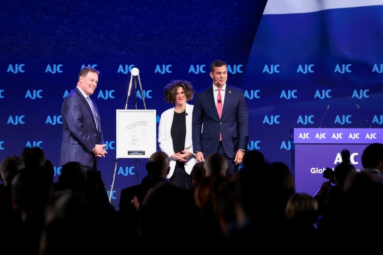 Paragyuan President Santiago Pena with Dina Siegel Vann and Tony Meye at AJC Global Forum 2025