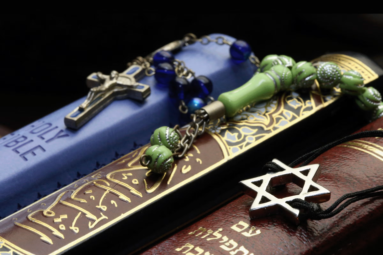 Photo of Bibles and Quran, interfaith symbols of Christianity, Islam and Judaism, the three monotheistic religions