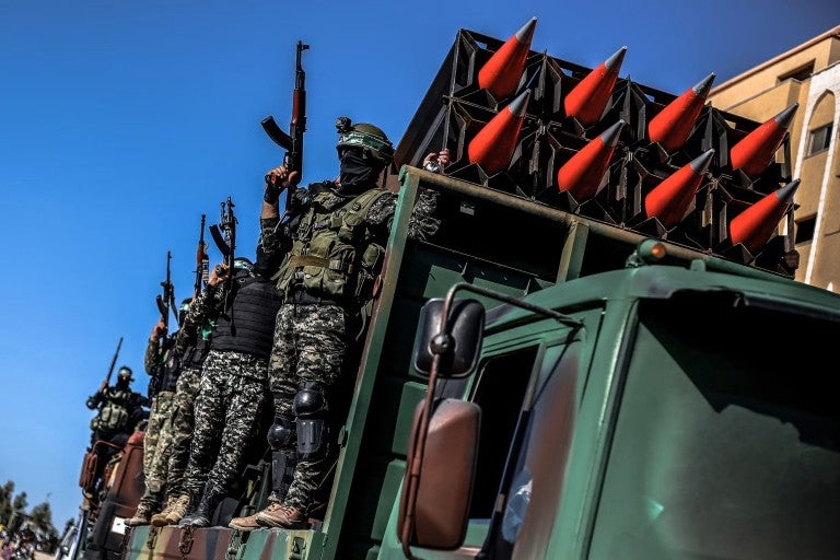 Members of Hamas display rockets during a military parade