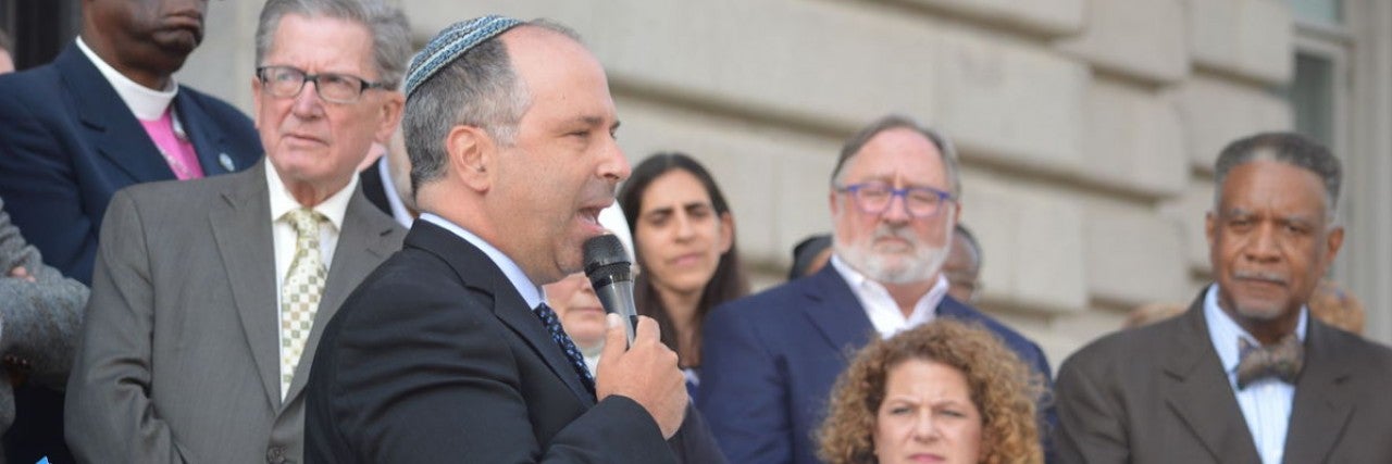 Photo of Rabbi Robert A. Nosanchuk of Anshe Chesed Fairmount Temple in Beachwod speaking to a crowd from the steps of Cleveland City Hall