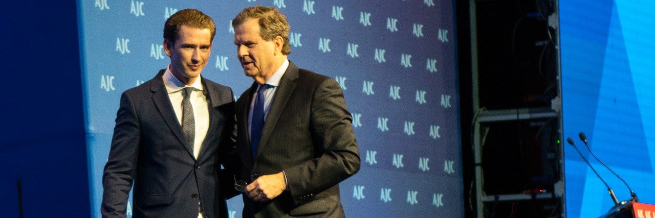 Photo of AJC CEO David Harris and Austrian Chancellor speaking at AJC Global Forum