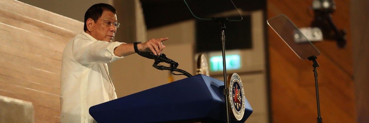 Philippine President Duterte speaks at an event in front of the podium.