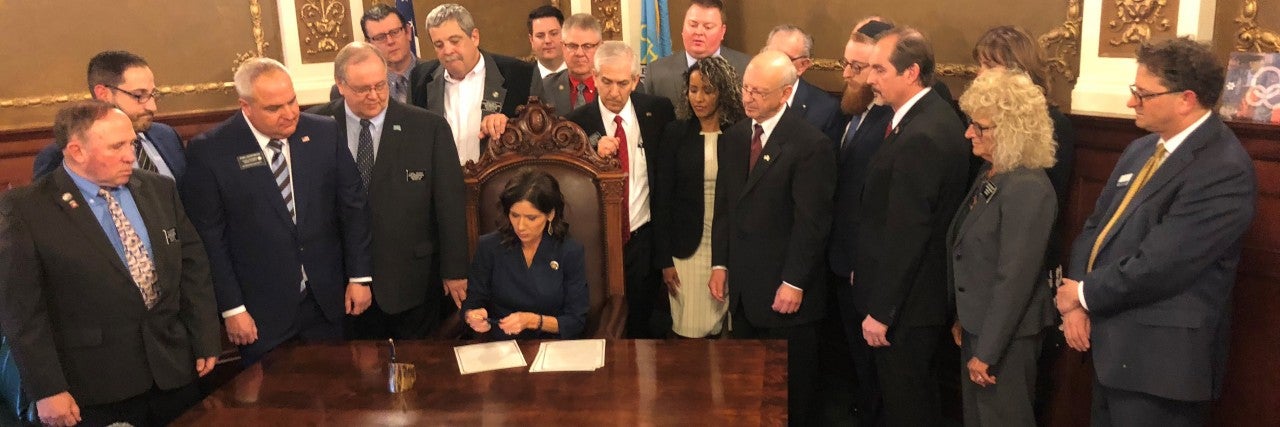 Photo of Governor Noem signing BDS legislation.