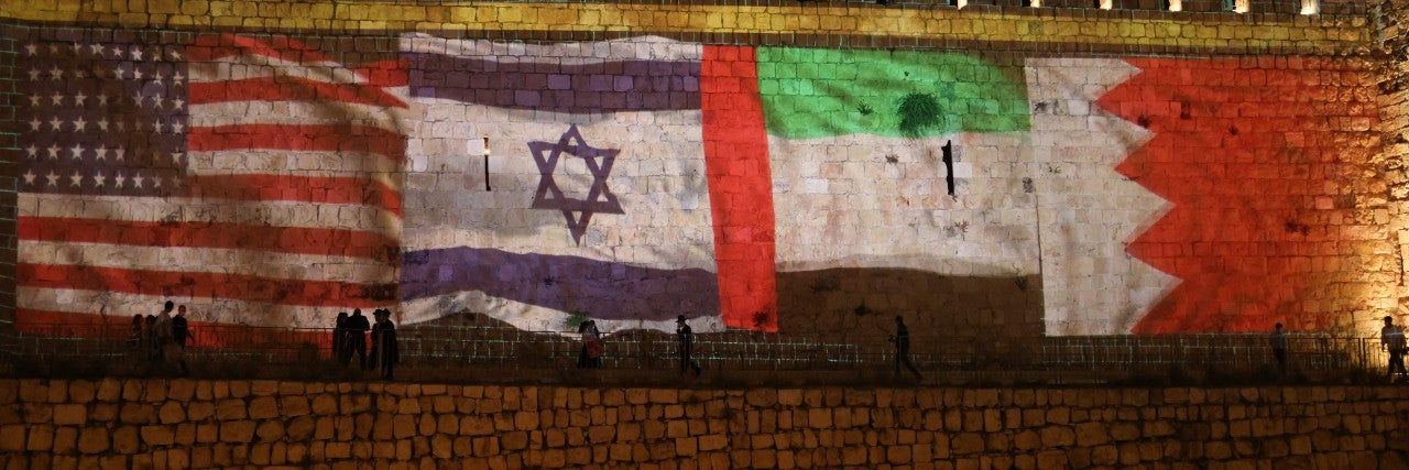 Flags of the US, Israel, UAE, and Bahrain alight the wall of the Old City of Jerusalem 