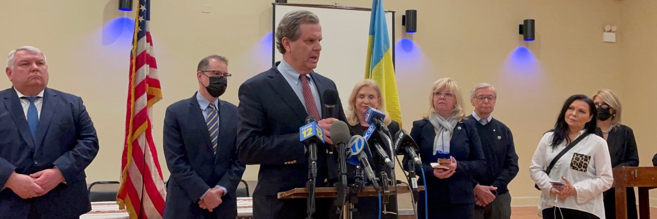 AJC CEO David Harris speaks at a podium at a press conference in New York City.