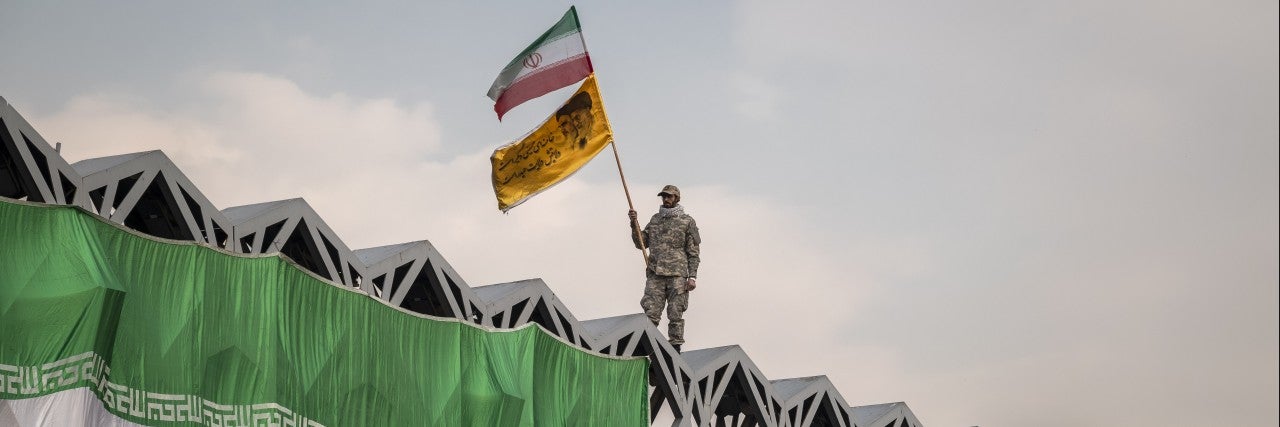 Man holding Iran flag