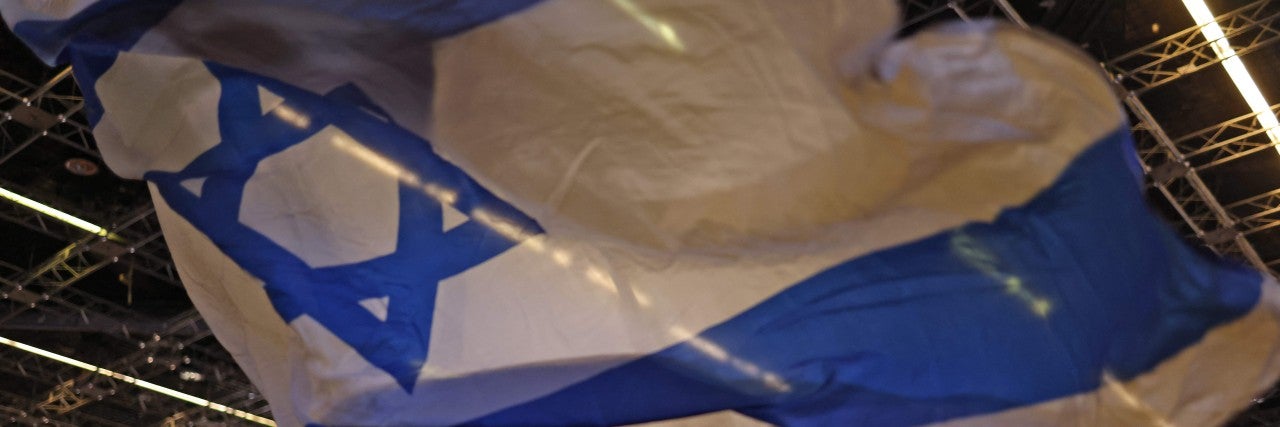 Man waving an IsraeliFlag