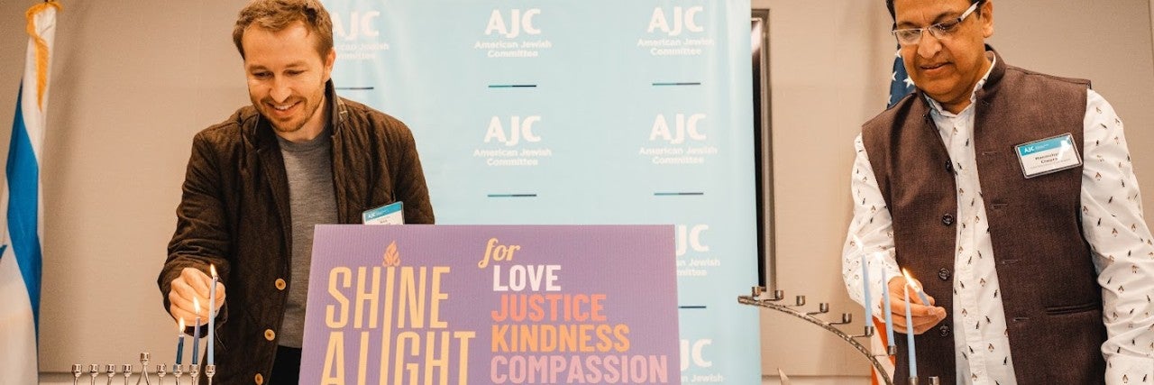 AJC Los Angeles 2022 Hanukkah - Melvoin and Chopra light candles