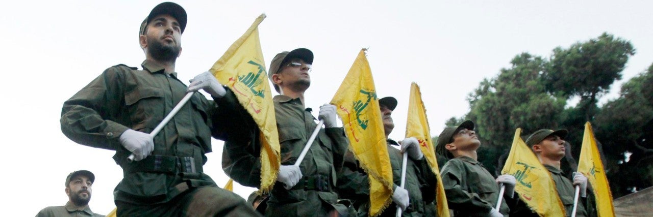 Hezbollah flags with militants marching