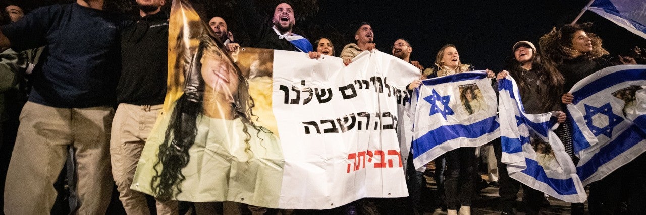 People celebrate the release of Isreali hostages from Hamas captivity at Sheba Medical Center in Ramat Gan, Israel, Jan. 19, 2025. Three Israeli women, released from Hamas captivity in Gaza, arrived in Israel on Sunday, the first day that a ceasefire agreement between Israel and Hamas took effect, according to Israeli officials. The three -- Emily Damari, 28, a British-Israeli; Doron Steinbrecher, 30, a veterinary nurse; and Romi Gonen, 23, abducted from the Nova music festival -- were finally released afte