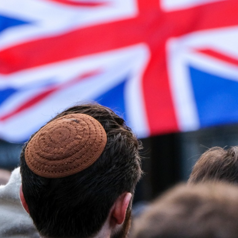 Man wearing kippah and British Jack flag