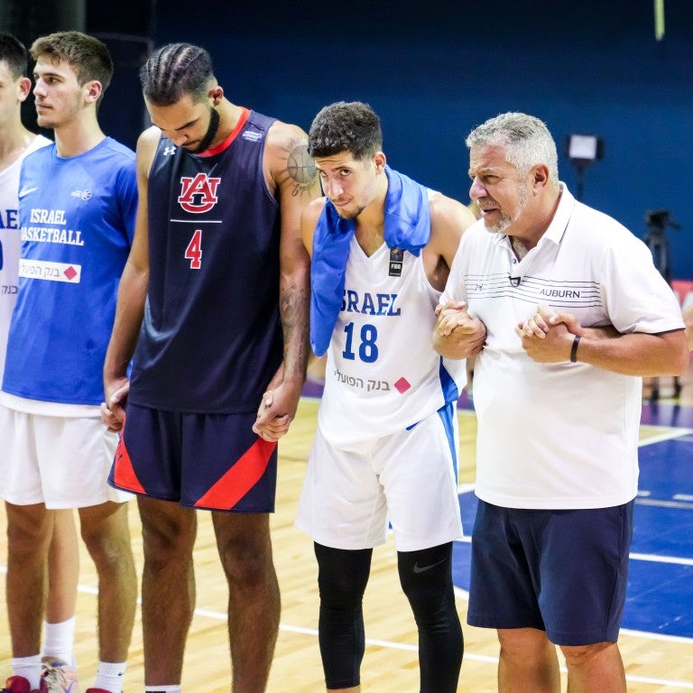 Photo of Bruce Pearl and Auburn University Men's Basketball Team arm in arm with Israeli National Team