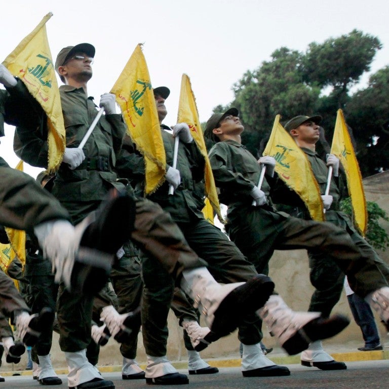 Hezbollah flags with militants marching