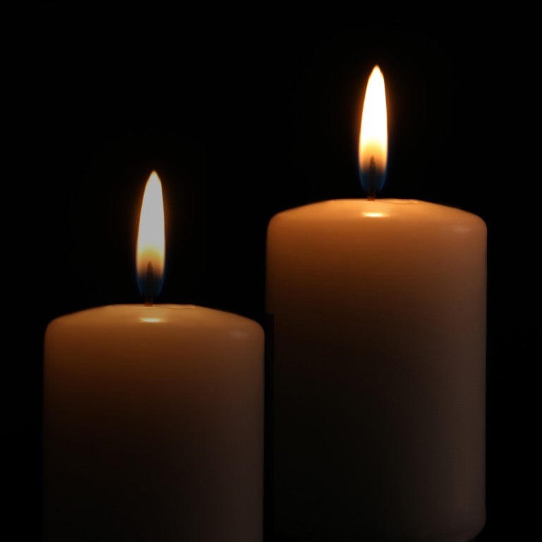 2 Candles on a black background