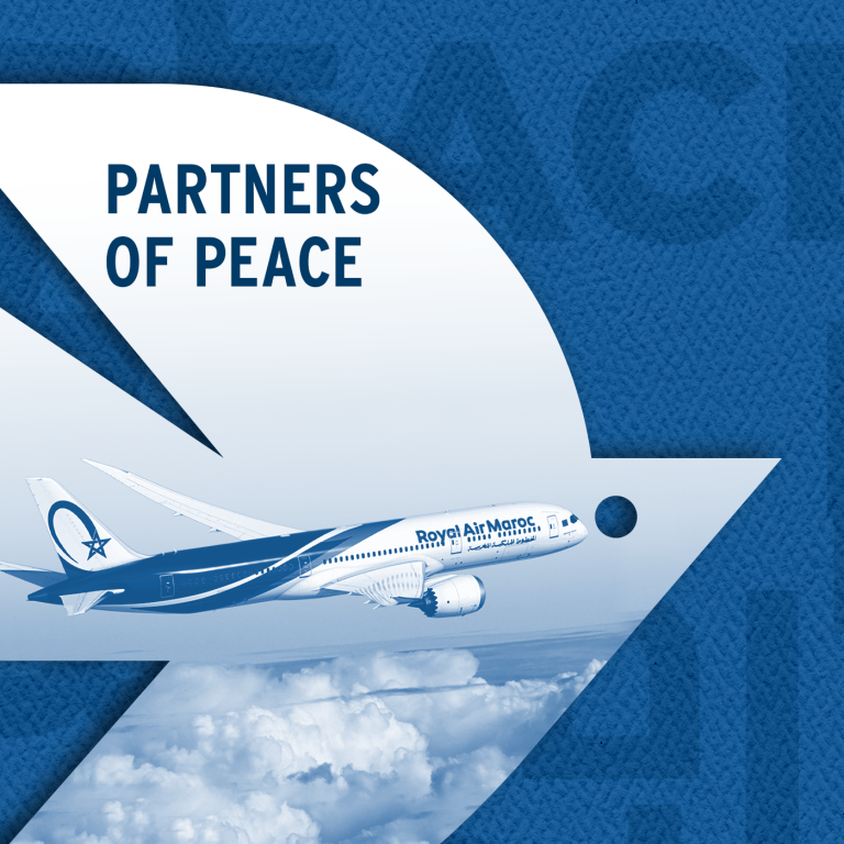 White dove over a dark blue background with peace written in three languages: Hebrew, Arabic, and English. Photo inside the dove reads "Partners of Peace" and shows an image of a Royal Air Maroc plane in flight, over clouds.