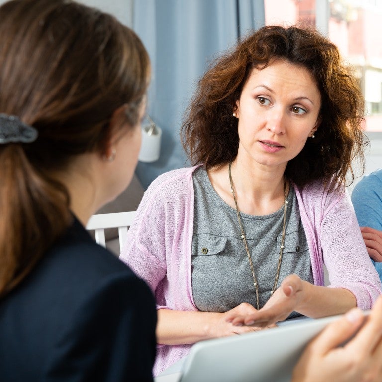 Woman gestering and speaking with students